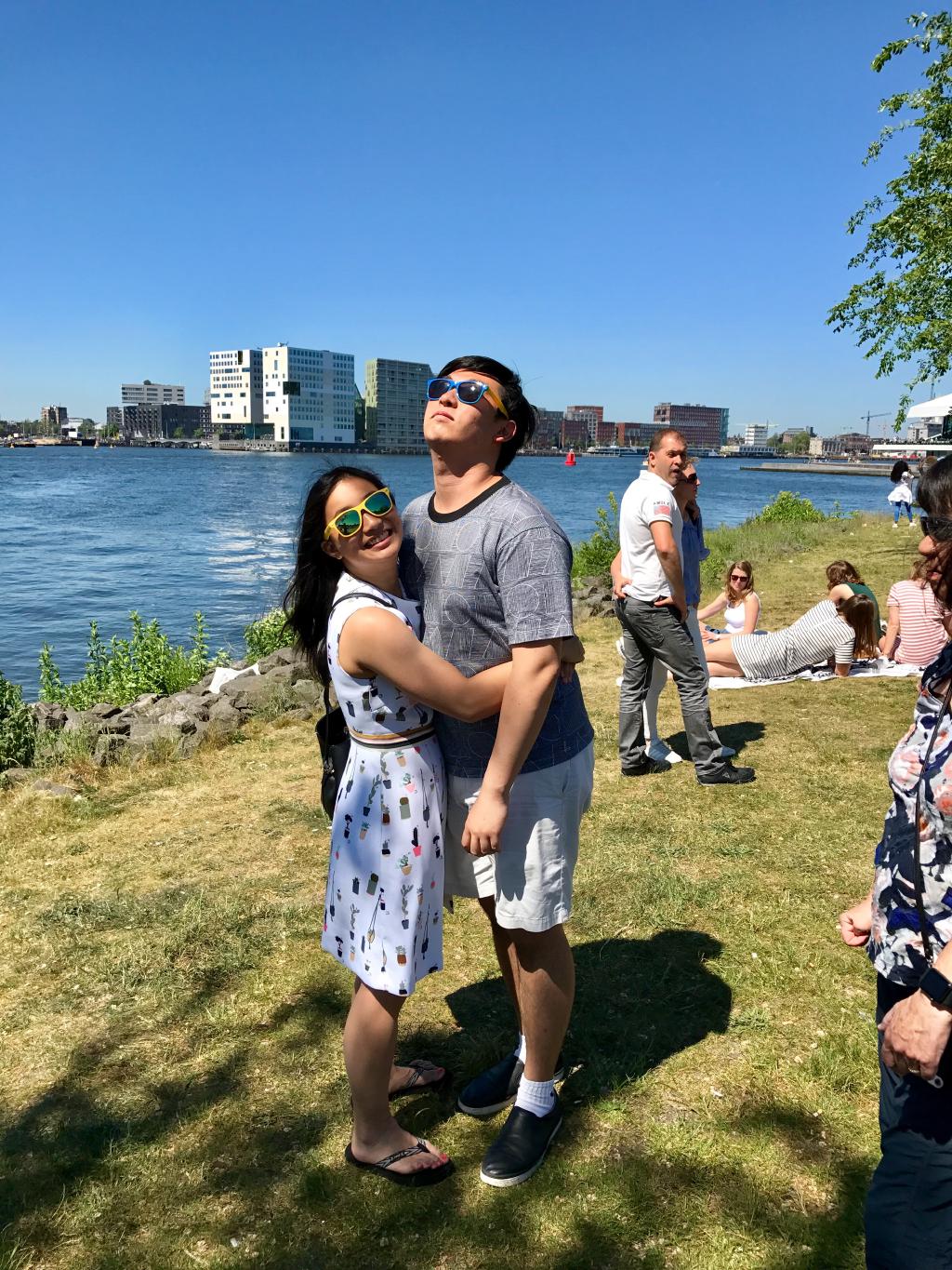 Kelly and Eric hugging during a sunny day in a park in the Netherlands