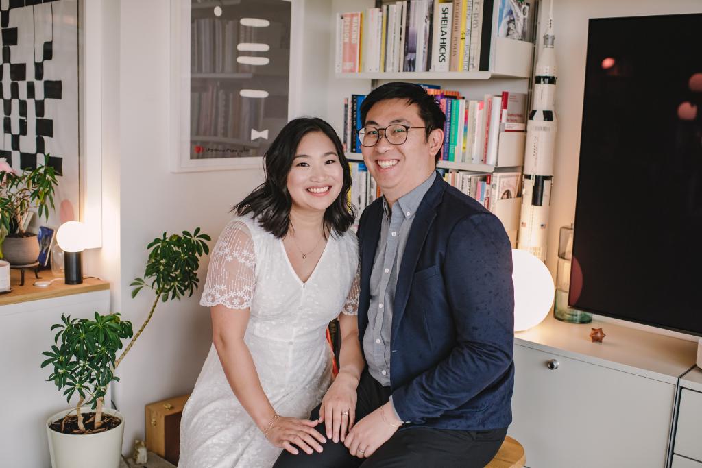 Kelly and Eric smiling, with a plush penguin figurine in the background