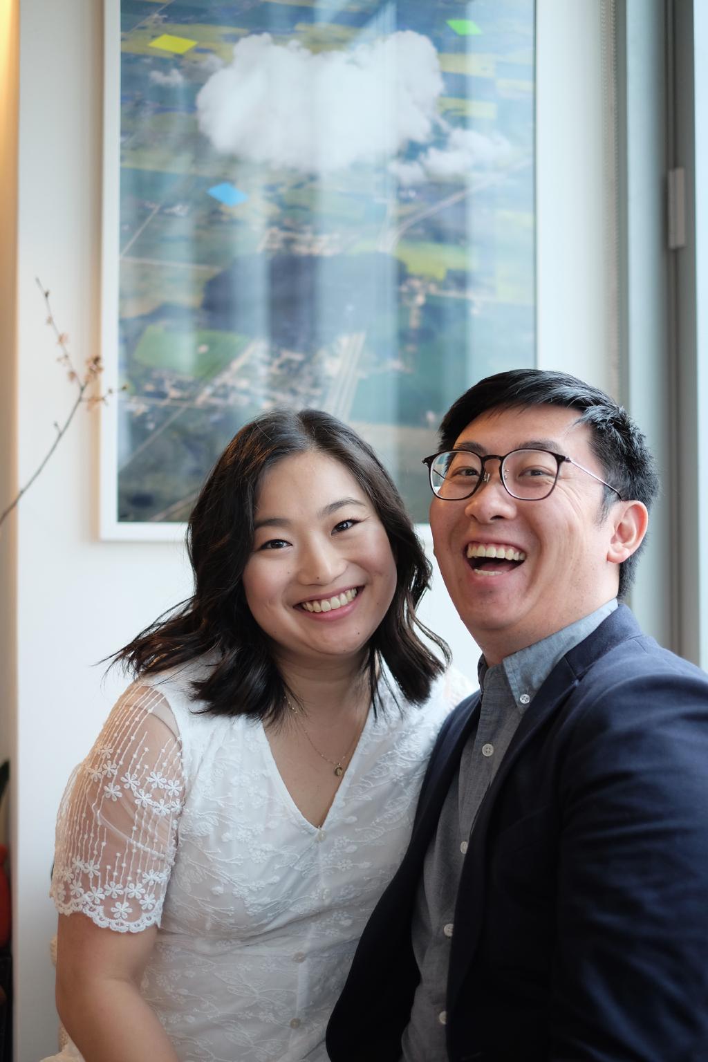 Portrait of Kelly and Eric where Kelly is smiling and Eric is laughing