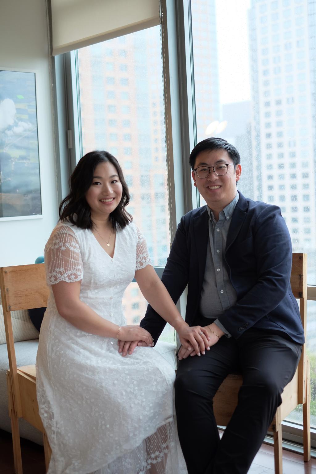 Kelly and Eric sitting on wooden chairs designed by Italian designer Enzo Mari that we built during COVID